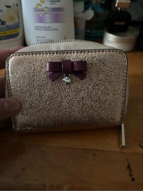 kate spade Rose Gold Metallic Zip Wallet with Purple Bow